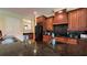 Spacious kitchen with granite countertops, dark wood cabinets, and breakfast bar at 29731 Chapel Park Dr, Wesley Chapel, FL 33543
