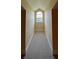 Long hallway with carpet and arched window at 29731 Chapel Park Dr, Wesley Chapel, FL 33543