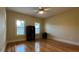 Hardwood floor bedroom with two windows and a bookcase at 29731 Chapel Park Dr, Wesley Chapel, FL 33543