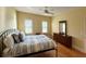 Spacious bedroom featuring hardwood floors and a dresser at 29731 Chapel Park Dr, Wesley Chapel, FL 33543