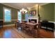 Formal dining room with hardwood floors, chandelier, and fireplace at 29731 Chapel Park Dr, Wesley Chapel, FL 33543