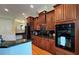 Well-equipped kitchen boasting dark wood cabinets and granite countertops at 29731 Chapel Park Dr, Wesley Chapel, FL 33543