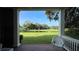 Serene view from covered porch of pond and lawn at 29731 Chapel Park Dr, Wesley Chapel, FL 33543