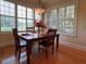 Bright breakfast nook with wooden table, built-in bench, and plantation shutters at 29731 Chapel Park Dr, Wesley Chapel, FL 33543