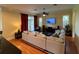 Bright living room boasts hardwood floors, sectional sofa and access to patio at 29731 Chapel Park Dr, Wesley Chapel, FL 33543