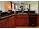 Kitchen with granite countertops, double sink, and access to the Gathering room at 29731 Chapel Park Dr, Wesley Chapel, FL 33543