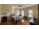 Bright bedroom with hardwood floors and window shutters at 29731 Chapel Park Dr, Wesley Chapel, FL 33543