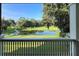 Scenic backyard view with pond and lush landscaping at 29731 Chapel Park Dr, Wesley Chapel, FL 33543