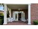 Brick patio with seating area, ceiling fan, and lush greenery at 29731 Chapel Park Dr, Wesley Chapel, FL 33543