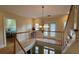 Elegant upper hallway with chandelier and hardwood floors at 29731 Chapel Park Dr, Wesley Chapel, FL 33543