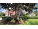 Brick home with mature landscaping and driveway at 29731 Chapel Park Dr, Wesley Chapel, FL 33543