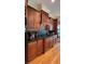 Modern kitchen with dark wood cabinets, granite counters, and stainless steel appliances at 29731 Chapel Park Dr, Wesley Chapel, FL 33543
