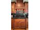 Elegant kitchen with custom cabinetry, granite countertops, and a stylish range hood at 29731 Chapel Park Dr, Wesley Chapel, FL 33543