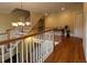 Elegant upper hall with hardwood floors, chandelier, and staircase at 29731 Chapel Park Dr, Wesley Chapel, FL 33543