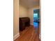 Hardwood floor hallway with roll top desk and access to bedroom at 29731 Chapel Park Dr, Wesley Chapel, FL 33543