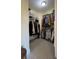 Well-organized walk-in closet with hanging rods and shelves at 29731 Chapel Park Dr, Wesley Chapel, FL 33543