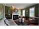 Cozy living room features a fireplace, comfy seating, and large windows at 29731 Chapel Park Dr, Wesley Chapel, FL 33543