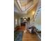 Grand two-story entryway with hardwood floors and a staircase at 29731 Chapel Park Dr, Wesley Chapel, FL 33543
