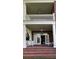Two-story porch with brick flooring and seating at 29731 Chapel Park Dr, Wesley Chapel, FL 33543