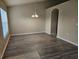 The open dining room is bright with wood floors and plenty of space for entertaining at 12161 Cavern Rd, Spring Hill, FL 34609