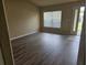 The bright living room features hard wood floors, a large window, and fresh paint at 12161 Cavern Rd, Spring Hill, FL 34609