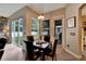 Dining space featuring hardwood floors, backyard access, and modern pendant lighting at 1926 Rutherford Dr, Dover, FL 33527