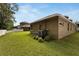 Exterior view of the house featuring well-maintained backyard at 1926 Rutherford Dr, Dover, FL 33527