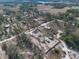 Aerial view of house and lot, surrounded by trees and other homes at 38545 Burger Ln, Dade City, FL 33523