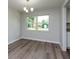 Dining room with new flooring and chandelier at 38545 Burger Ln, Dade City, FL 33523