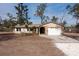 House exterior with gravel driveway and mature trees at 38545 Burger Ln, Dade City, FL 33523