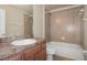 Bathroom with tub, toilet and wood vanity at 12161 Cavern Rd, Spring Hill, FL 34609