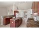 Kitchen boasts dark wood cabinets, an island, and tile floors at 12161 Cavern Rd, Spring Hill, FL 34609