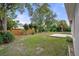 Backyard with grassy area, wooden fence, and patio at 12161 Cavern Rd, Spring Hill, FL 34609