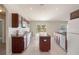 Kitchen with dark wood cabinets, center island, and tile flooring at 12161 Cavern Rd, Spring Hill, FL 34609