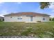 House's backyard with a patio and a large grassy area at 12161 Cavern Rd, Spring Hill, FL 34609