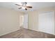 Bedroom with carpet, ceiling fan and double door closet at 12161 Cavern Rd, Spring Hill, FL 34609