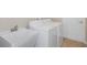 Laundry room with washer, dryer, and utility sink at 12161 Cavern Rd, Spring Hill, FL 34609