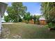Landscaped backyard with wooden fence and mature trees at 12161 Cavern Rd, Spring Hill, FL 34609