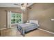 Bright bedroom with a queen bed, ceiling fan, and large window at 1122 Vinetree Dr, Brandon, FL 33510