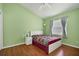 Bright bedroom with wood floors and a comfortable bed at 1122 Vinetree Dr, Brandon, FL 33510