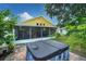 Hot tub in backyard with screened patio and landscaping at 1122 Vinetree Dr, Brandon, FL 33510