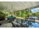Screened patio with pool table, dining table and hot tub at 1122 Vinetree Dr, Brandon, FL 33510