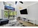 Comfortable living room with a large TV and access to a patio at 1122 Vinetree Dr, Brandon, FL 33510