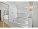 Clean bathroom with a large soaking tub and a window at 1122 Vinetree Dr, Brandon, FL 33510