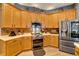 Spacious kitchen with stainless steel appliances and light wood cabinets at 1926 Rutherford Dr, Dover, FL 33527