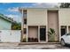 Front view of a two-story house with a black door and landscaping at 1905 E Mulberry Dr # 2, Tampa, FL 33604