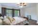 Bedroom with a wooden bed frame and sliding glass doors leading to a balcony at 1905 E Mulberry Dr # 2, Tampa, FL 33604