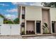 Front view of a two-story house with a black door and landscaping at 1905 E Mulberry Dr # 2, Tampa, FL 33604