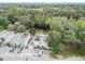 Aerial view showing a townhome with parking and a wooded backdrop at 1905 E Mulberry Dr # 2, Tampa, FL 33604