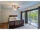 Bedroom with a wooden bed frame and sliding glass doors to balcony at 1905 E Mulberry Dr # 2, Tampa, FL 33604